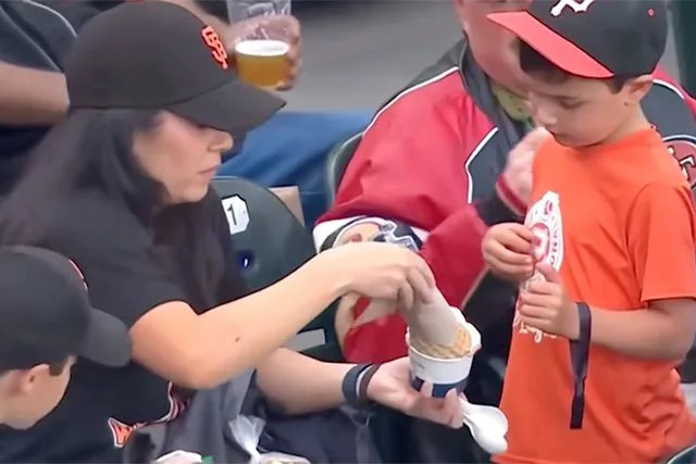 Internet Divided After Woman Is Accused of ‘Robbing’ Child of Half His Ice Cream in Viral Jumbotron Moment