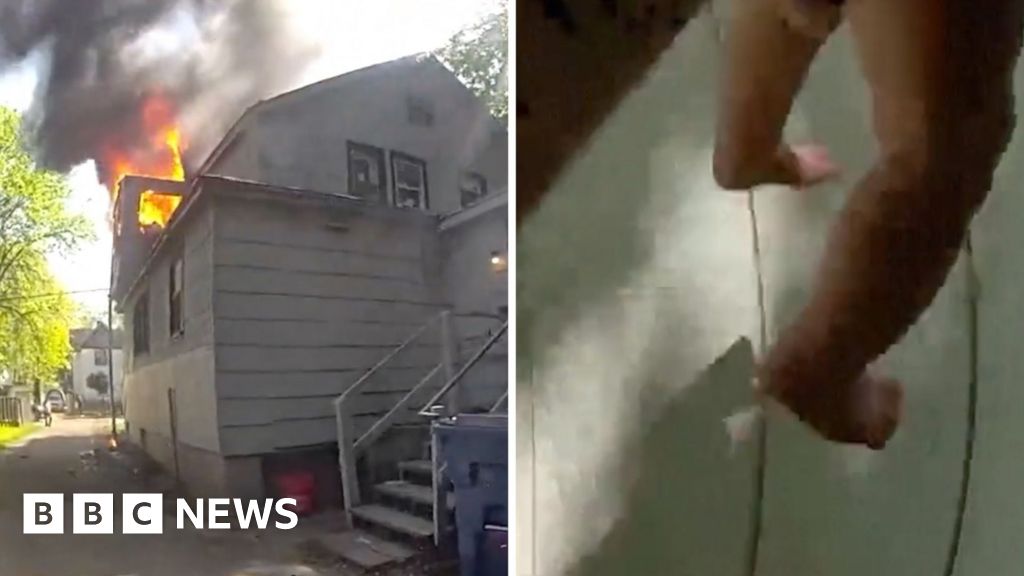 Police officer catches baby thrown from window of house on fire