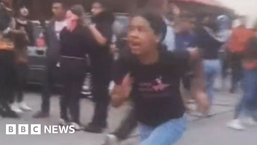 People flee as building collapses on the outskirts of Caracas